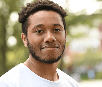 A student smiles at the camera