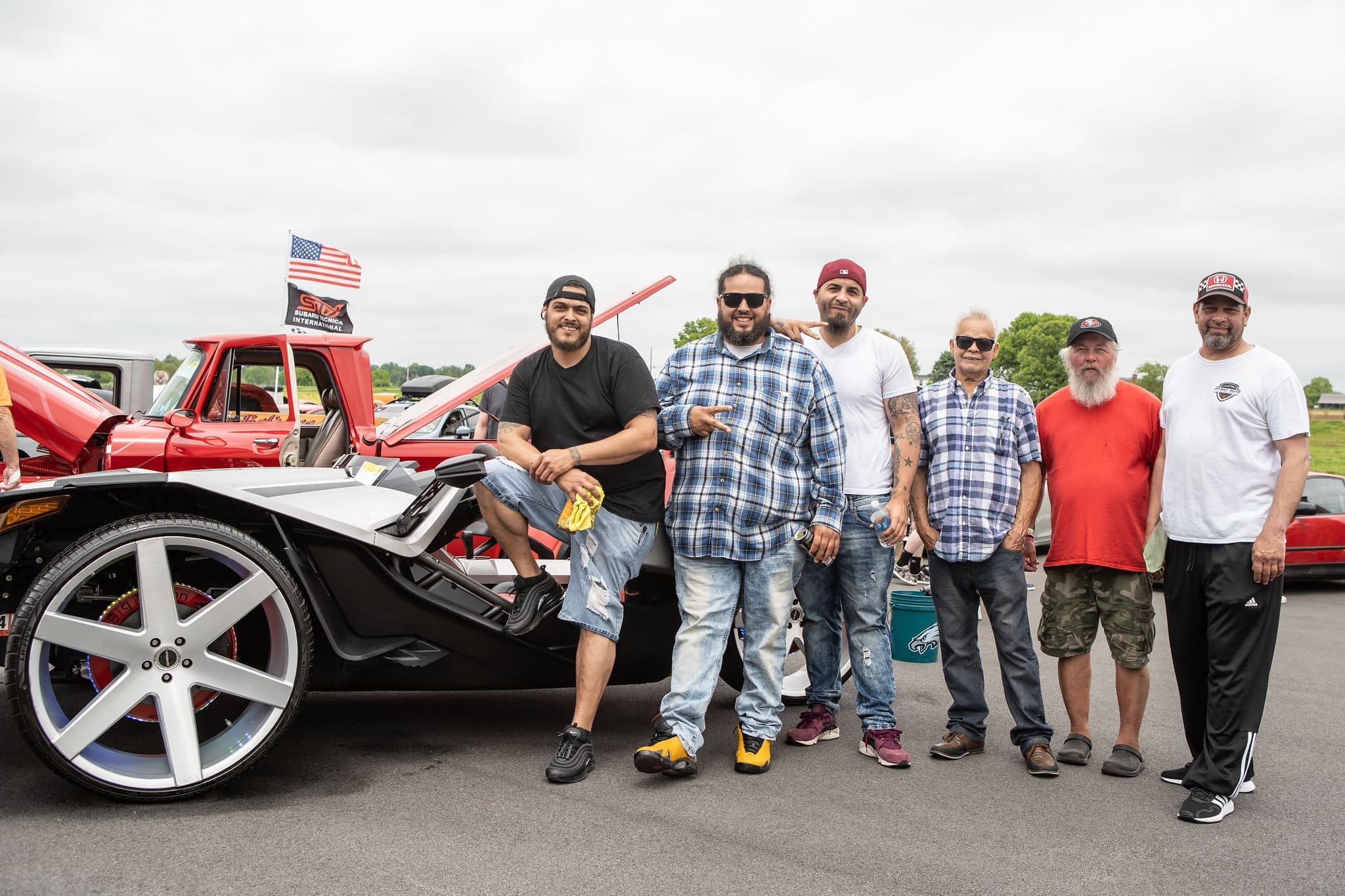 alumni and friends at an alumni car show event.