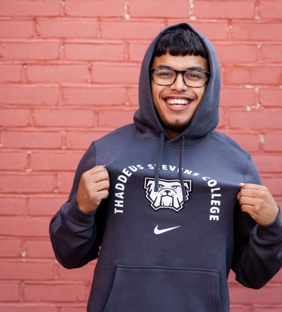 A student wearing a Thaddeus Stevens College sweatshirt