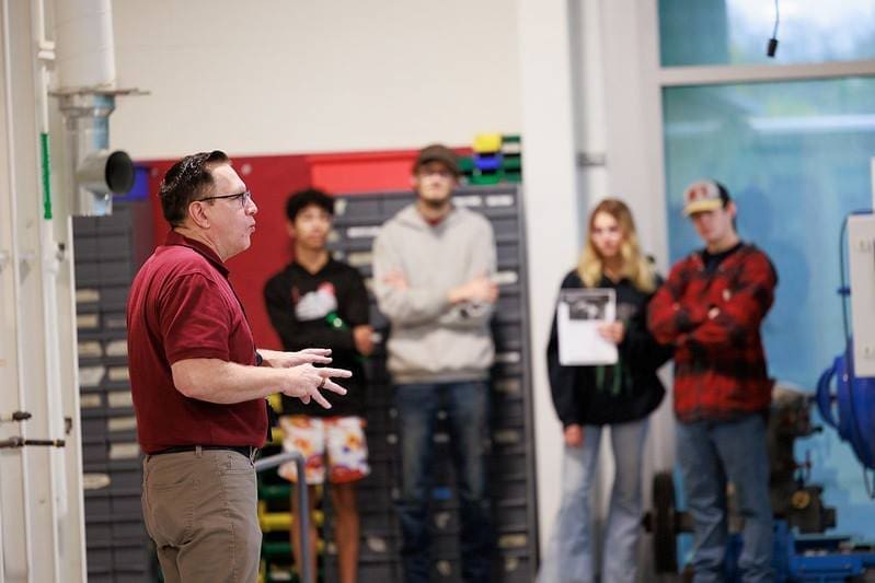 Thaddeus Stevens College Instructor talking to prospective students and parents at open house 