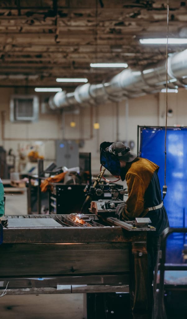 A student learns to weld in the lab. 