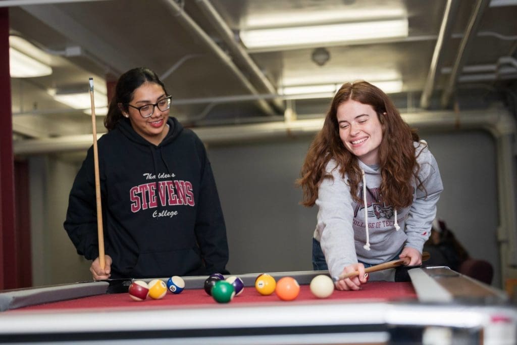 Two students playing pool