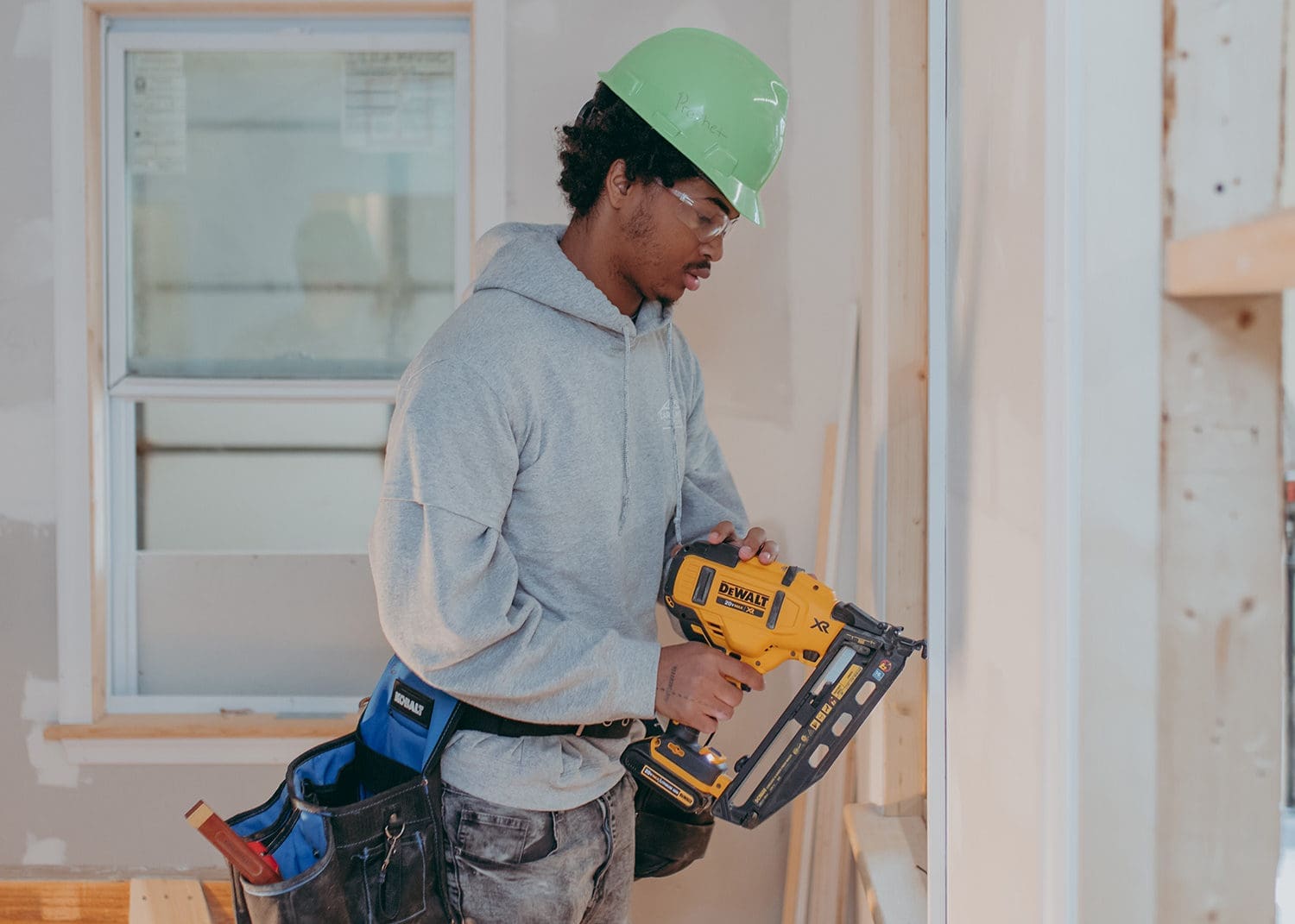 Student in carpentry program working on our housing project.