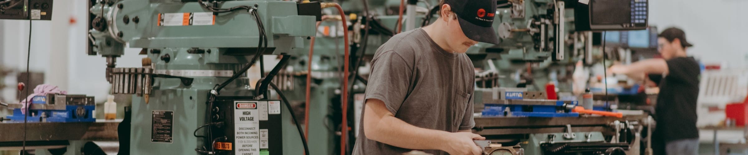 A student works among the machines in the Computer Integrated Machining program.