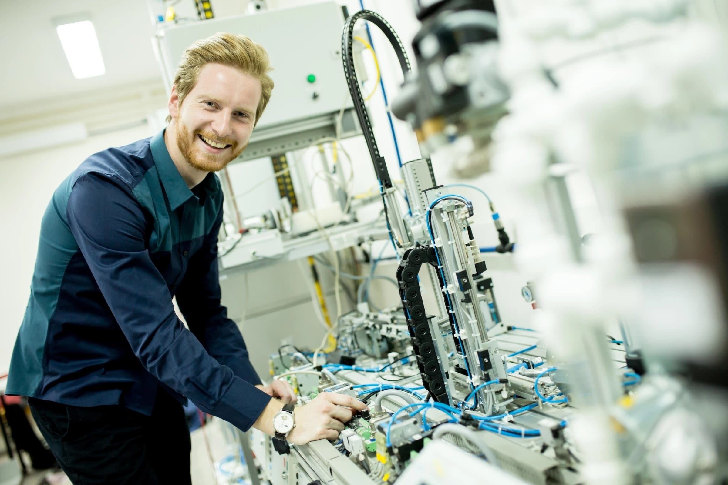 An electro mechanical student works with robotics in a lab. 