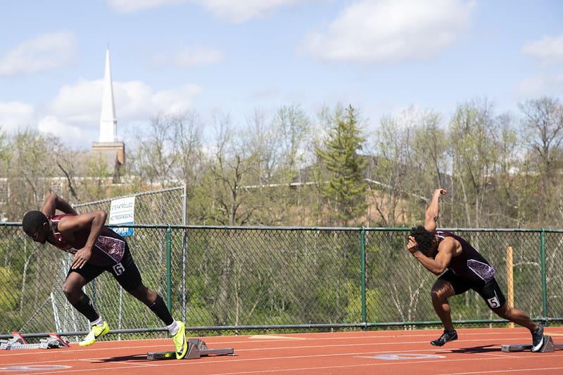 A track and field athlete at the start of a race. 