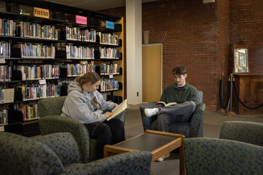 Thaddeus Stevens College of Technology students sitting in a lounge area reading books at the Library. 