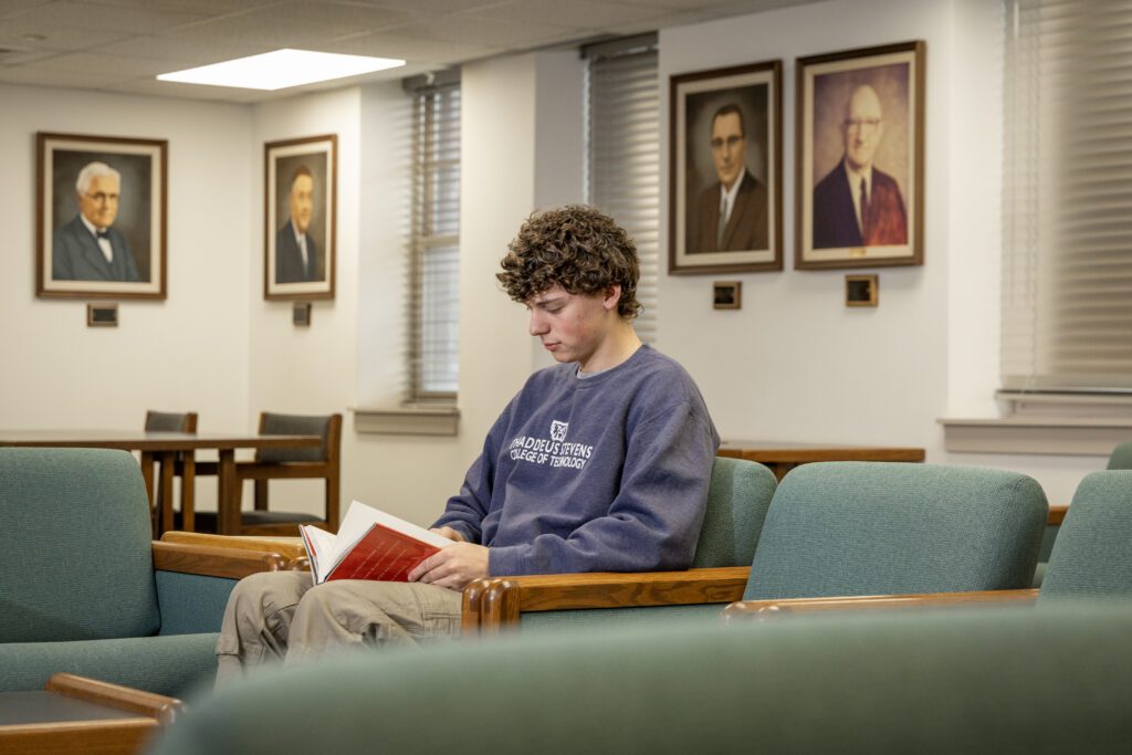 Thaddeus Stevens College of Technology student reading book in the Library. 