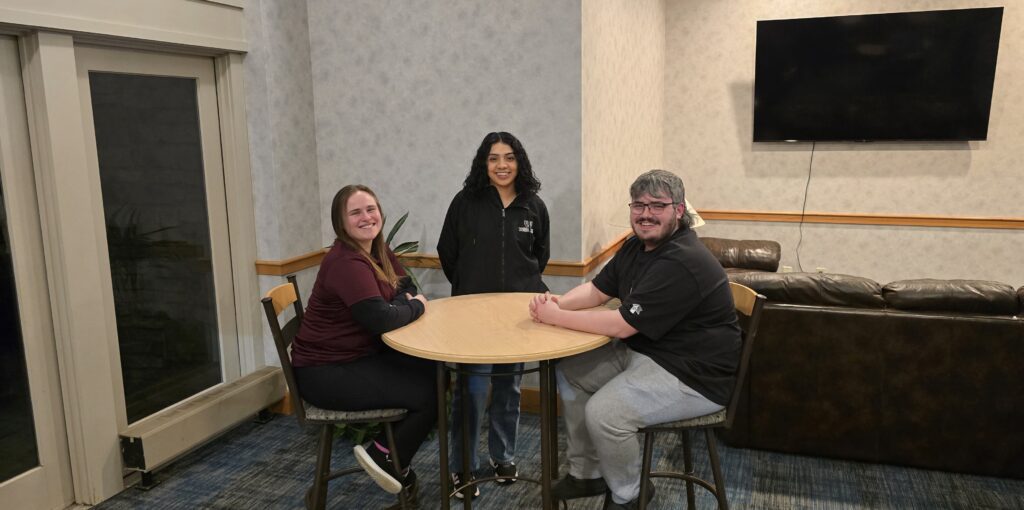 Thaddeus Stevens College of Technology students sitting in Reighard Hall lounge area smiling.